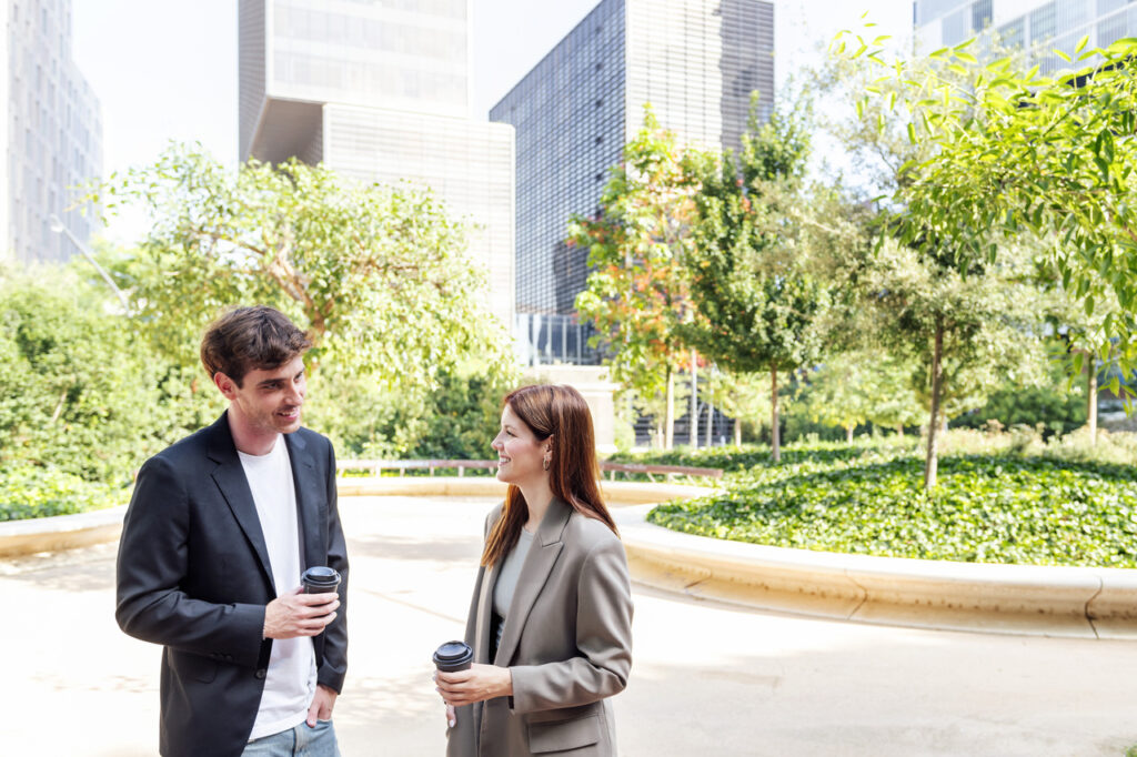 man and woman talking near office buildings in dallas