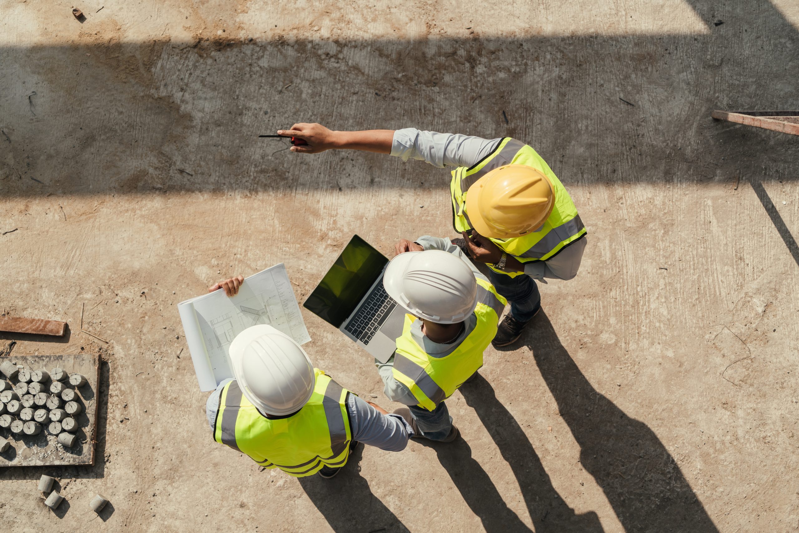 Engineering and construction professionals reviewing plans with a tablet