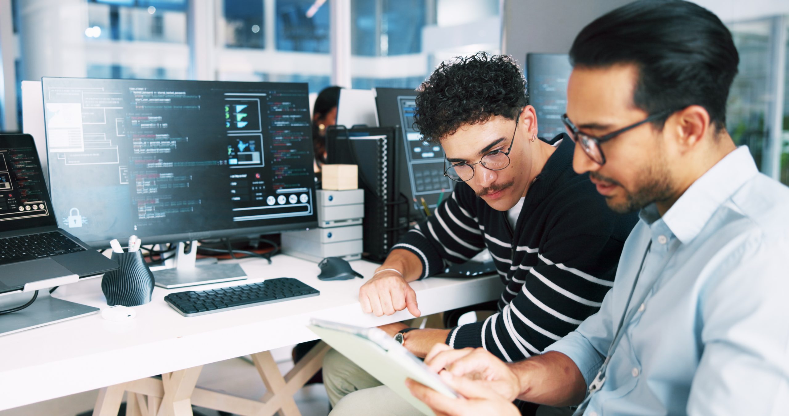 Technology professionals collaborating at a workstation