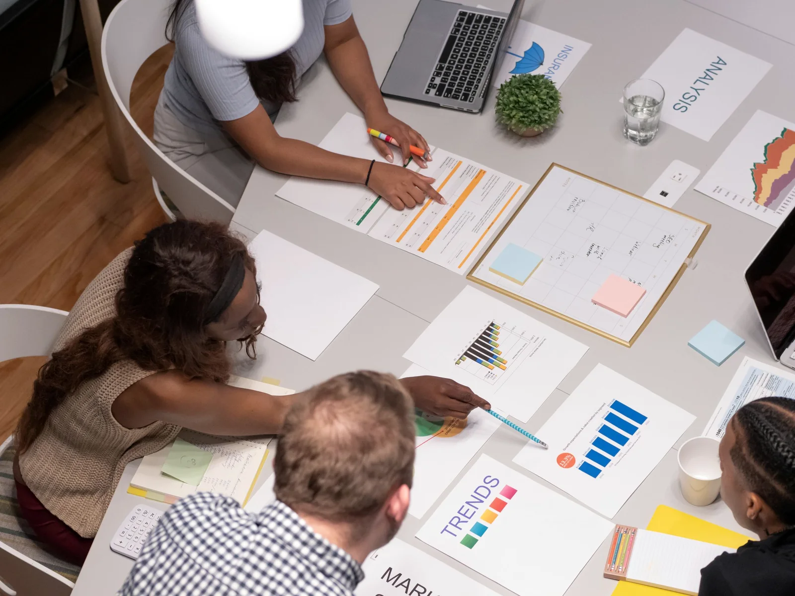 Business team reviewing charts and priorities around a table
